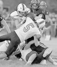 Ainsworth defense wraps up an Arcadia-Loup City running back. Photo by Jennifer Schuett