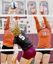 Cheyan Temple and Jocelyn Good go up for a block against Stuart’s Lacey Paxton.