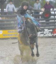 The Brown County Fair left many of its riders a muddy mess after falling from their roughstock. A bronc rider pictured above loses his hat during his ride.