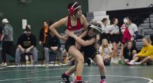 Maya Macias works to get an escape against her opponent at the Elkhorn Vally Invitational.