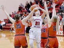 Madelyn Goochey drives through three Valentine defenders for two points in Ainsworth’s win over Valentine.