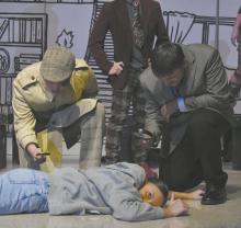Kristofer Hitchcock (left) and Carson Koch (right) observe the dead body, played by Ava Graff.