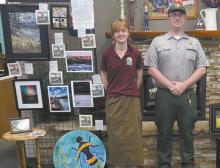 Rangers set up the art display that is open for viewing at the Ainsworth Public Library through the month of July.
