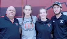 Two Ainsworth Girls Wrestlers advance to District compeition. Jolyn Pozehl and Megan Jones placed in the top four of their weight classes at Subdistrict and now advance to Districts on February 9th in Broken Bow. Pictured are (Left to Right) Head Coach Todd Pollock, Megan Jones, Jolyn Pozehl and Assitant Coach Oren Pozehl.