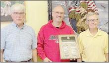 Phil Fuchs (left) and Jerry Ehlers (right) were named as Co-Lions of the Year for the year 2022-23 and presented a plaque by Lions Club President Steve Dike (center).