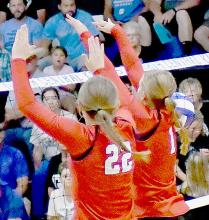 Gracyn Painter (22) and Kendyl Delimont (1) go up for a double block and score a point for the Bulldogs.