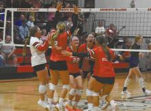 The Lady Bulldogs converge to celebrate a massive game-ending block by junior Raelynn Reagan. The team had not beat the Knights any of the pair's four meetings last season and the team showed much excitement breaking the dry spell.