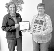 Geraldine Erickson presents Connie Lentz with a certificate and her name was placed on the Lion of the Year plaque.