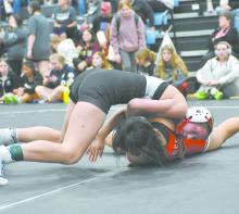 Megan Jones works to pin Ellie Genesis of South Sioux City. Jones placed fourth at the Summerland Invite.