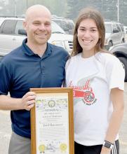 Jared Hansmeyer is retiring from teaching at Ainsworth High School and retiring as the Activities Director and Cross Country Coach. To honor Hansmeyer, the 2022-23 Cross Country Team contacted the State of Nebraska and asked that Hansmeyer be made an Admiral in The Great Navy of the State of Nebraska which Govenor Pillen granted. Katherine Kerrigan (right) presented Hansmeyer (left) with this Admiralty plaque at the State Track Sendoff on Thursday, May 18th.