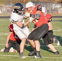 Riggin Blumenstock ripped the ball from grasp of the Elm Creek player for an Elm Creek turnover.