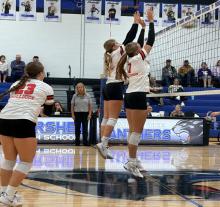 Jaylee Good and Ava Graff (7) attempt to block a hit during the Hershey Tournament. Payton Sears (23) prepares to cover in case the ball drops.