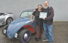 A great turnout of cars, friends, family and community members filled the evening with food, fellowship and plenty of support for Shayne McConnel as he continues his battle with cancer. Pictured are event coordinator Rozalynn Goss and McConnell along with a fitting ending to a special night: Shayne’s own Volkswagen Beetle was voted the People’s Choice winner. He received a $100 H&amp;R Food Center gift certificate with the honor.