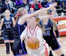 Kendyl Delimont went under the Lady Cougars defender and scored two of her 17 points.