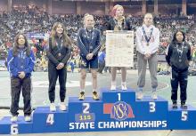 Jolyn Pozehl stands on the podium following her third place finish in the girls 115 lb. weight class at the 2023 NSAA State Wrestling Championships. This is her second year on the winner’s podium at state wrestling.