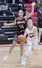 Saylen Young drives past CWC’s Annabel Waldo and is looking for a shot in Ainsworth’s 74-41 win.