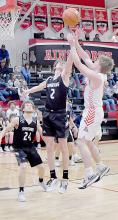 Jacob Held goes up for two points against Issac Jensen of Boyd County. The Bulldogs defeated the Boyd County Spartans 69-46.