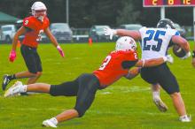 Zaine Evans (2) lunges after Niobrara/Verdigre's Jacob Motacek (25) during the team's recent home game. Evans led the team with 14 total tackles, nine of which were solo, and one for loss.