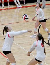 Karli Kral, Lauren Ortner and Saylen Young work together as a team in making sure this serve heads back over to the opponents side.