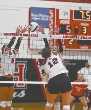 Sophomore Ava Graff (right) and senior Willa Flynn (left) attempt to block a hit by St. Mary's Tatum Ickes (12).