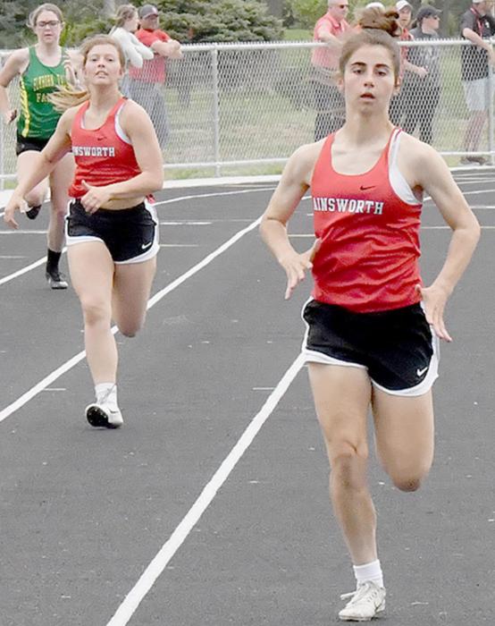 Saylen Young (left) and Maia Flynn (right) give their all in the 200 Meter Dash Preliminaries trying to qualify for the 2022 State Track Meet.