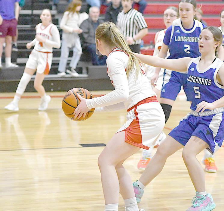 Sophomore Kenley Welke pulls down a rebound and looks to pass it to a teammate.