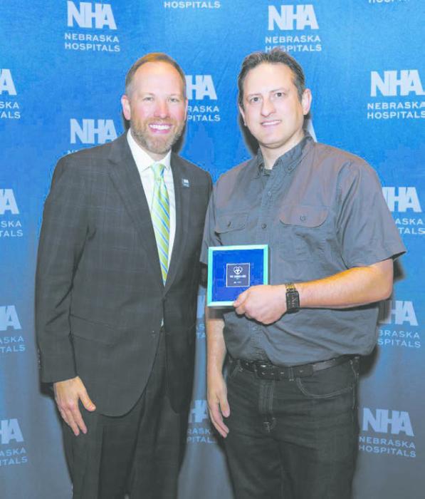 Michael Clay (right) is pictured receiving his award with NHA president Jeremy Nordquist, President and CEO of the NHA.