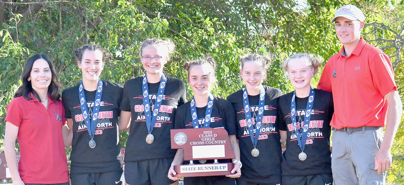 The Ainsworth Girls Cross Country Team brought home the 2023 Class D Cross Country State Runner-Up trophy from the 2023 NSAA State Cross Country Championships held in Kearney on October 20th. Team members are (Left to Right) Co-Head Coach Katie Winters, Katherine Kerrigan, Emma Kennedy, Tessa Barthel, Preselyn Goochey, Kiley Orton and Co-Head Coach Trey Schlueter.