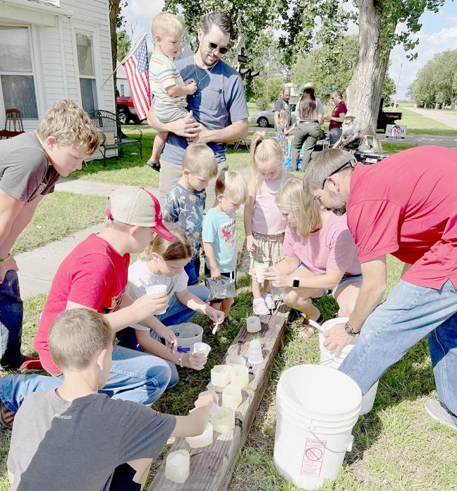 Shane Tucker, Paleontologist from Morrill Hall in Lincoln, showed children how to make plaster molds of fossil teeth.
