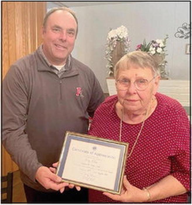 Lion President Dale Hafer (left) presents Mary Ann Allen (right) her late husband, Lion Jerry Allen’s 65-year certificate. (Right Photo)
