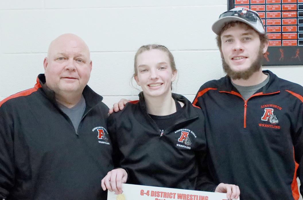 Jolyn Pozehl recorded her third District Wrestling Championship and will be headed to the 2024 NSAA State Wrestling Tournament in Omaha for the third straight year. Pozehl was crowned District Champion in the 110 lb. weight class at District Finals on February 9th in Broken Bow. She will be competing in the State Wrestling Tournament at the CHI Health Center in Omaha on February 15th, 16th and 17th. Pozehl is pictured at the right with Head Coach Todd Pollock (left) and Assistant Coach Oren Pozehl (right).