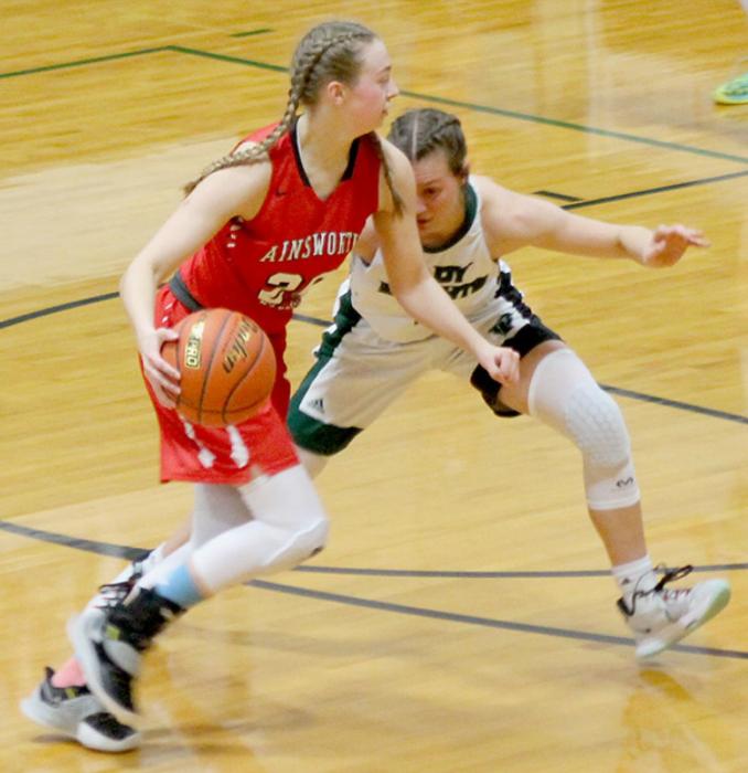 Kendyl Delimont dribbles the basketball against a tough Knights defender.