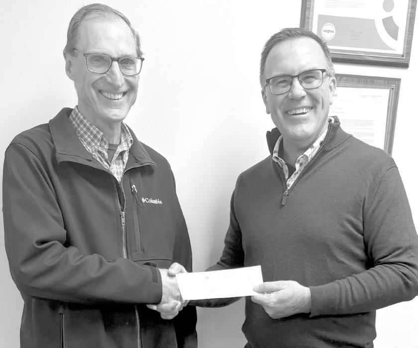 Pastor Gary Graesser (left) accepted the check for the Ainsworth Food Pantry from Scott Steinhauser (right), representing the Ainsworth Lions Club.