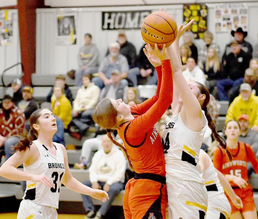 Jaylee Good attempts a shot, but gets blocked by Kalli Licking of Mullen.