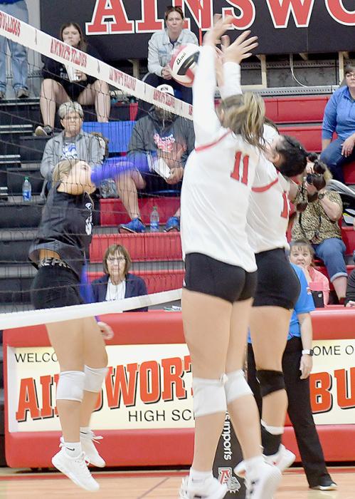 Karli Kral (11) and Dakota Stutzman (13) double up to block the volleyball hit by this O’Neill Eagle player.