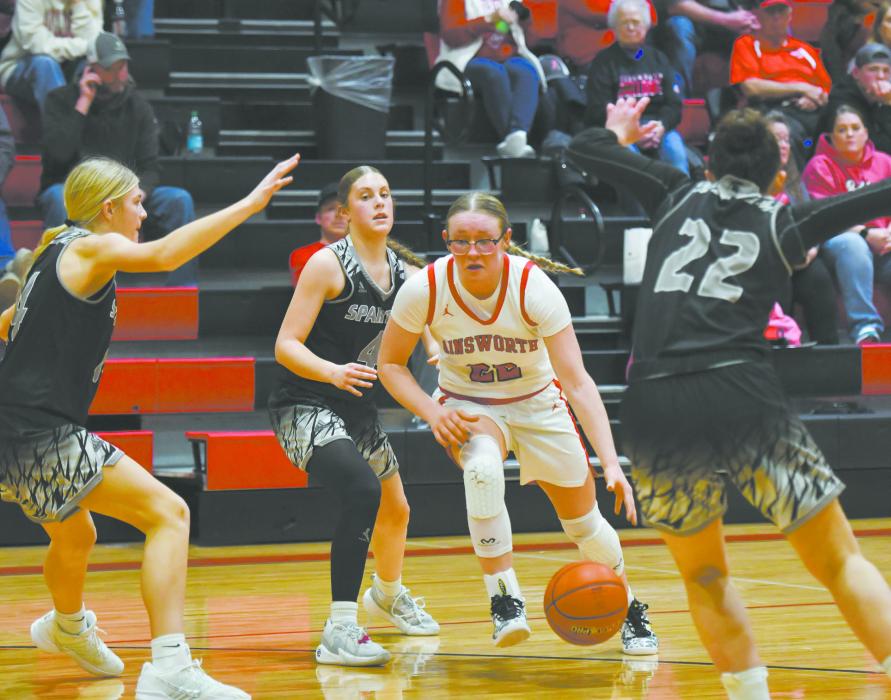 Gracyn Painter takes the ball to the hoop, bypassing three members of the Spartan defense.