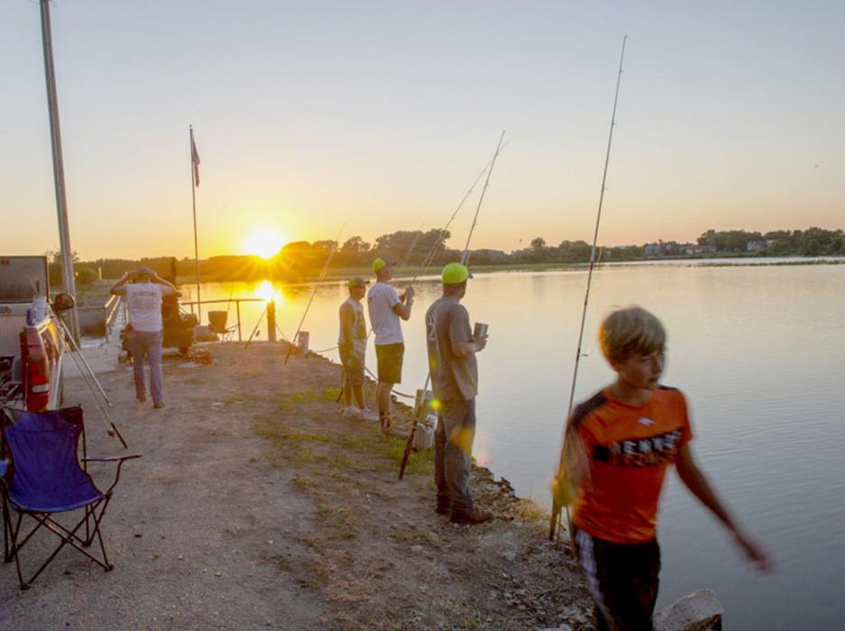 Anglers fish for catfish in July near sunset at Spalding Dam on the Cedar River in Greeley County. Eric Fowler, NEBRASKAland Magazine, Nebraska Game and Parks Commission