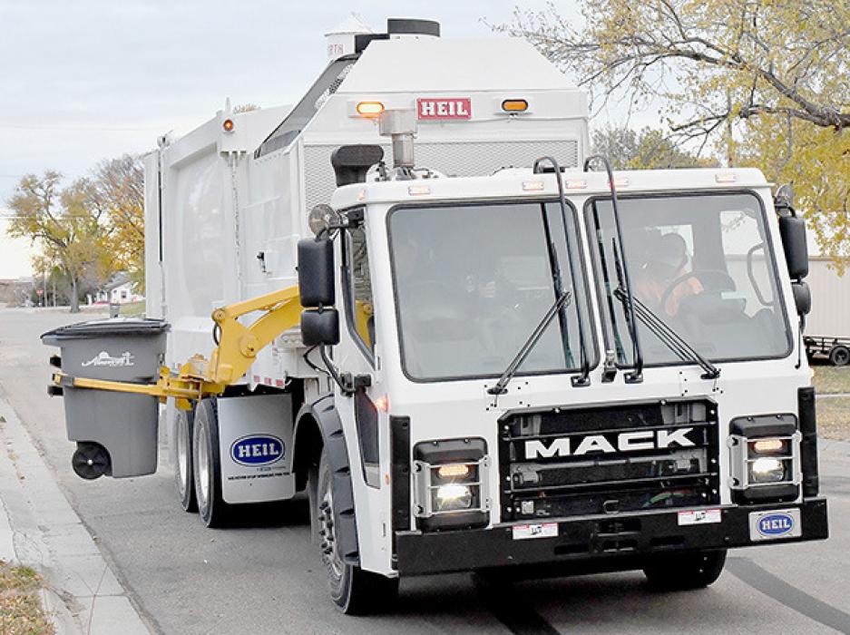 The tote is then lifted by the mechanical arm in preparation to dumping.