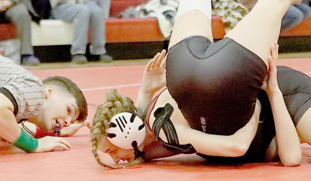 It took Jolyn Pozehl less than a minute to pin three of her opponents to take first place in the 115 lb. weight class.