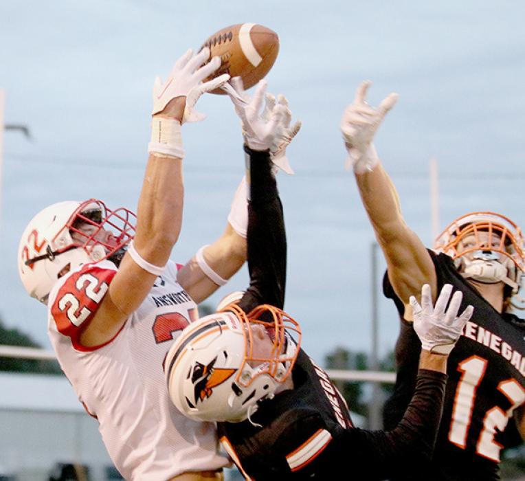 Carter Nelson goes over the top of double coverage to a pass reception. Nelson caught three passes for 63 yards and had one pass interception. Photos by Jennifer Schuett