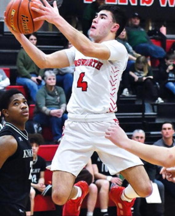 Witten Painter plays defense as his opponent from Mullen Chris Fernandez tries for a layup against the Sandhills-Theddrives down the court. ford Knights. He scored 187 points this season.