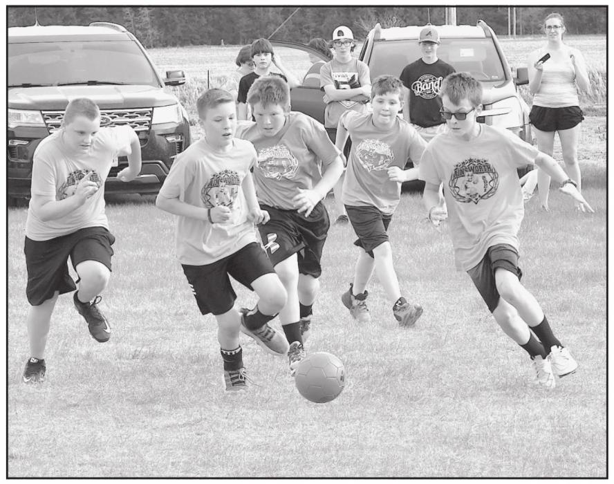 The race is on for the ball during April 30 soccer matches sponsored by the Ainsworth Youth Activities.