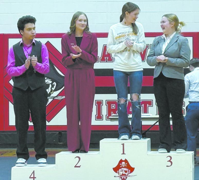 Madison Phares (fourth from left) placed third in poetry, qualifying her for the state tournament in Kearney on March 27th.