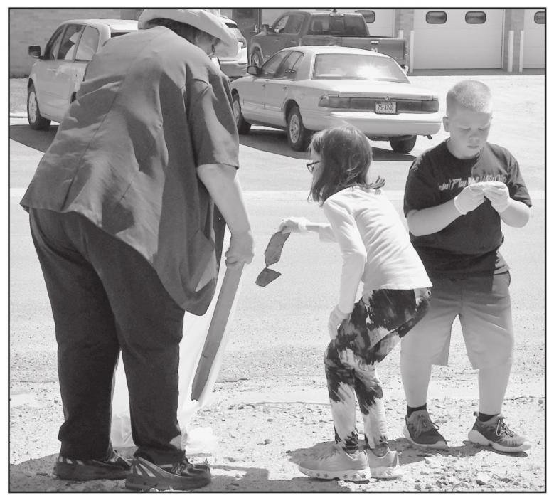 Elementary students pick up trash along the streets of Ainsworth.