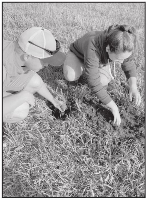 Two Senior students plant a tree in Ainsworth.