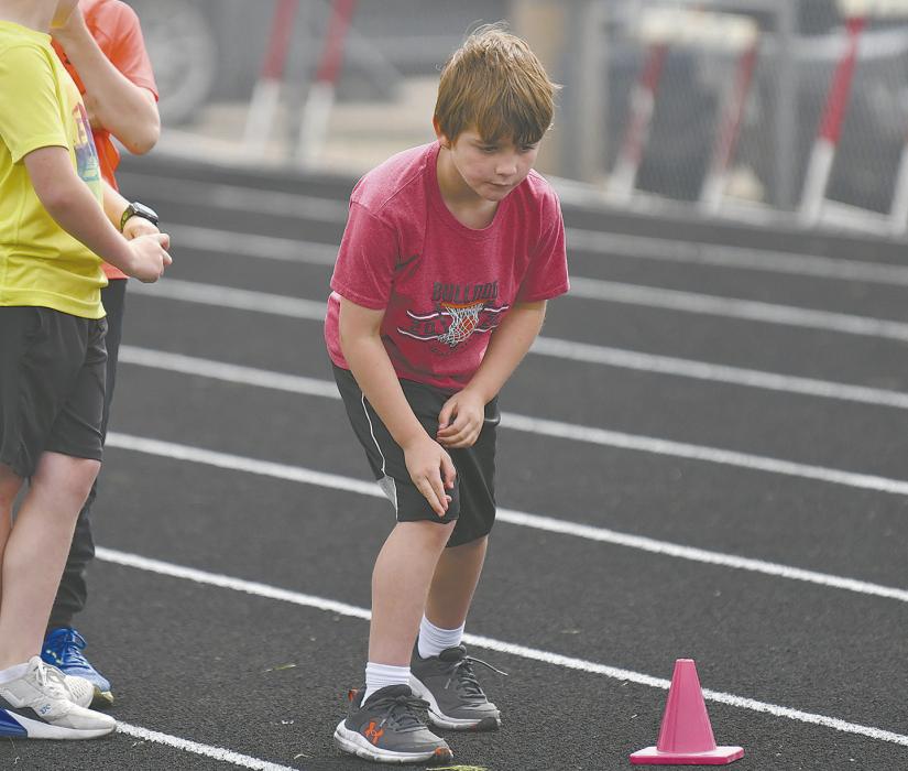 Third grader Keegan O’Hare prepares to run the cone shuttle relay during the track portion of the day.