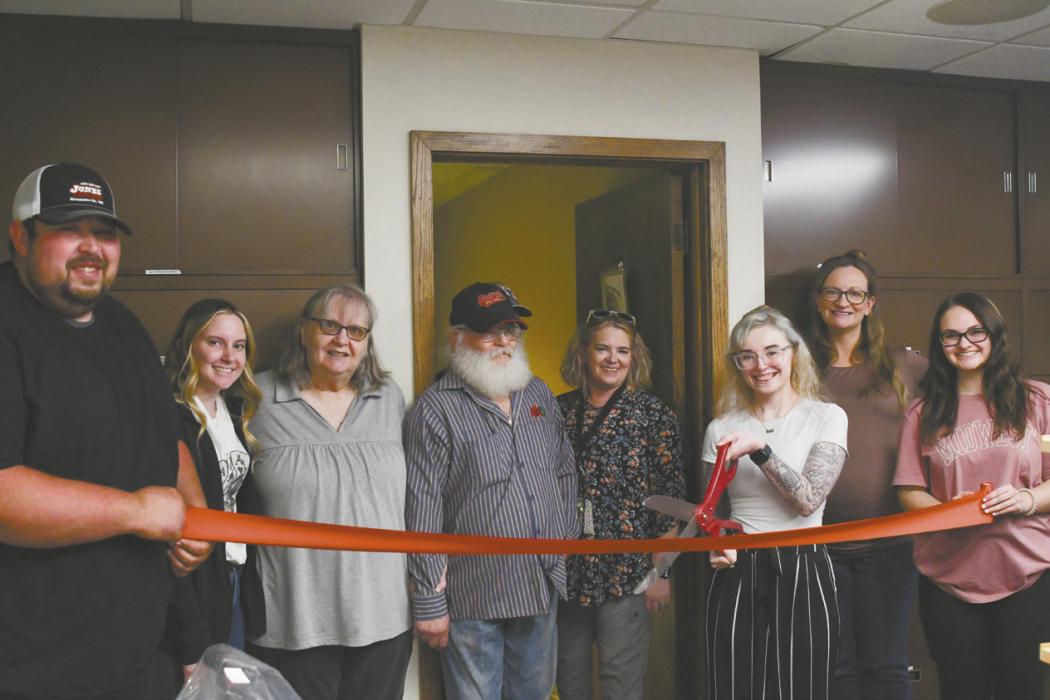 Dena Prinie cuts the ribbon in front of a Better Spirit Counseling Center located inside the Cassell Executive Offices Building on Main St. in Ainsworth.