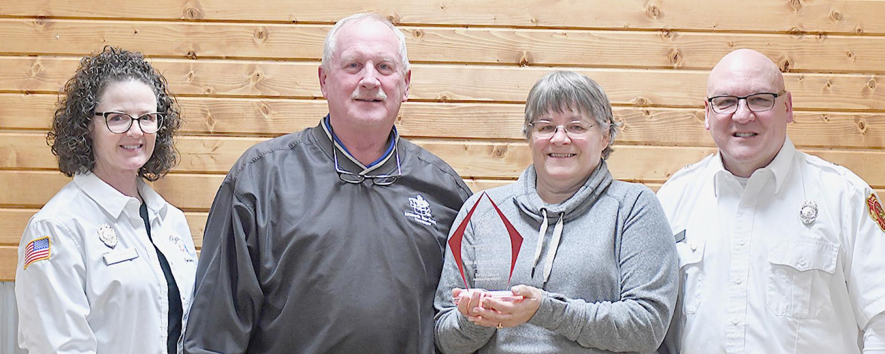 Community Members of the Year Award for years of outstanding support was presented to Rod and Kathy Worrell (center) by Brown County Ambulance Association President Ann Fiala (left) and Ainsworth Fire and Rescue Fire Chief Brad Fiala (right).