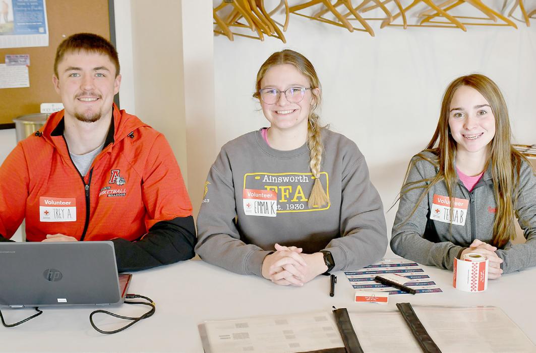 The Ainsworth FFA Chapter sponsored a blood drive on Tuesday, February 6th with the Red Cross. Thirty-six individuals donated to the cause. Bill Carr took his turn in the church as he donated to the blood drive. FFA Chamber Officers (left to right): President Trey Appelt, Vice President Emma Kennedy and Secretary Tessa Barthel helped with the blood drive signing in the donors as they arrived at St. Pius X Catholic Church.