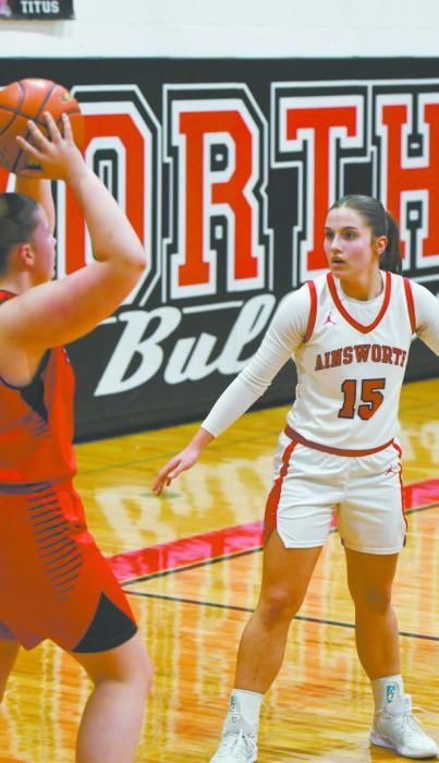 Willa Flynn (15) plays defense on Winside’s Ellie Topp. Flynn had two steals in the game against the Wildcats.